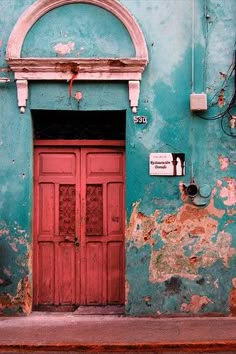 an old building with a red door and window