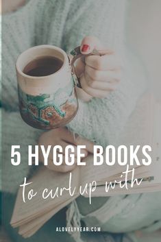 a woman holding a coffee mug with the words, 5 hygge books to curl up with