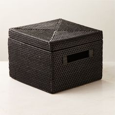 Woven rattan storage basket puts organic texture on display. Perfect on a bookshelf, the black basket is complete with open handles and a lid to keep things out of sight. CB2 exclusive.  -100% woven rattan -Made in Indonesia Emme Square Woven Black Rattan Storage Basket Black Storage Bins With Lids, Black Woven Basket, Rattan Storage Basket, Teak Storage, Small Storage Boxes, Black Rattan, Rattan Storage, Black Basket, Storage Bins With Lids