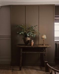 a table with two vases on top of it next to a radiator