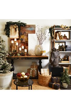 a living room filled with lots of furniture and christmas decorations on top of a table