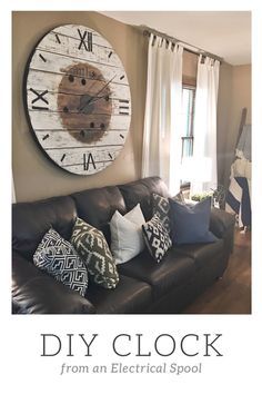 a living room filled with furniture and a large clock on the wall over the couch