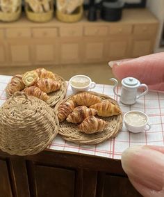 there are some croissants and coffee on the table