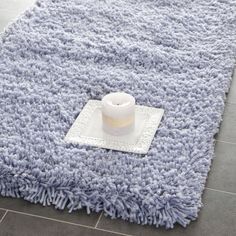 a blue rug with a candle on it