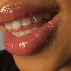 a close up of a person's mouth with white teeth