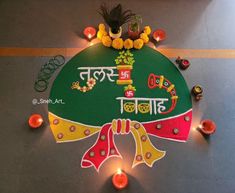 a colorful rangdi with candles and flowers on the floor