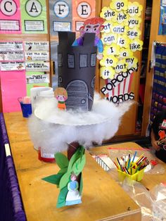 a classroom desk with some decorations on top of it and other items in the background