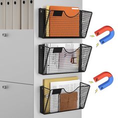 three metal bins holding files and folders on a white wall with magnets attached to them