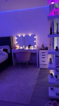 a bedroom with purple lighting and white furniture