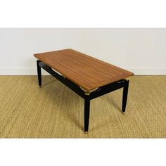 a wooden table sitting on top of a carpeted floor