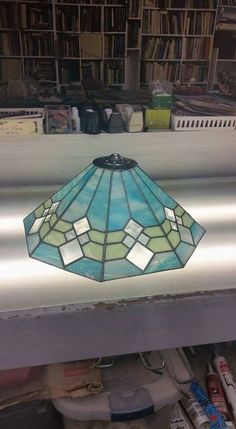 a stained glass lamp sitting on top of a table