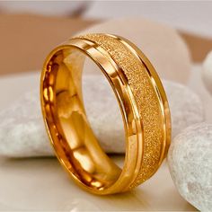 two gold rings sitting on top of each other