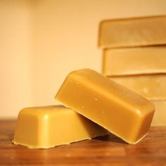 three bars of soap sitting on top of a wooden table