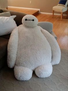 a large white stuffed animal sitting on top of a couch