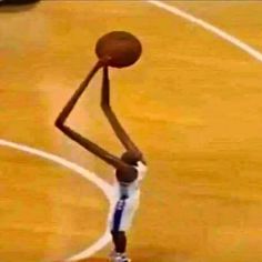 a basketball player is holding the ball in his right hand and stretching to dunk it