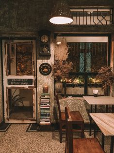 a room filled with lots of furniture next to a table and chairs in front of a window