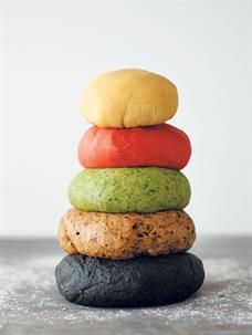 a stack of different colored donuts on top of each other