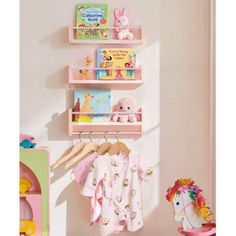 a baby's room with toys and bookshelves on the wall next to a toy horse