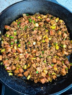 a skillet filled with ground beef and vegetables