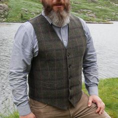 Its timeless quality makes this Irish tweed waistcoat well worth investing in if you have a penchant for classic Irish Design. Perfect for an all year round appeal. Full cloth back and front . Fully Lined. Lovely green Irish tartan with blue and red chech - very easy to match with other garments. Can be worn as formal or casual vest(ex with jeans) Featuring: -5 Button closing, -Darted front, -2 pockets(non functional). -Full tweed back. -Belted back. -Size chart on pic no. 10 Pictures taken at G Wool Vest Outfit, Peaky Blinders Style, Waistcoat Outfit, Mens Formal Vest, Irish Tartan, Irish Tweed, Men's Denim Style, Leather Waistcoat, Tweed Waistcoat