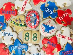 decorated cookies are arranged in the shape of hearts and numbers, with names on them