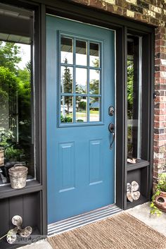 a blue front door with the words tuklyninteritors written on it