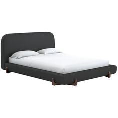 an image of a bed with white sheets and pillows on it's headboard