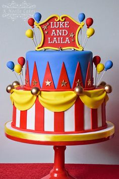 a circus themed cake with balloons on top