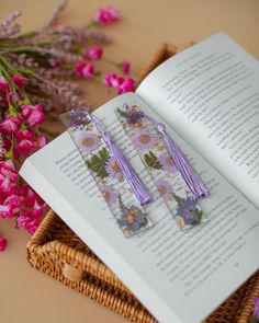 an open book with some purple flowers on it