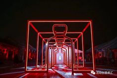 an empty room with red lights on the walls and floor, in front of a building