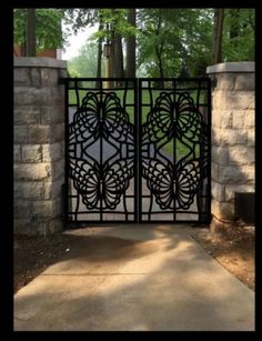 an iron gate in front of a stone wall