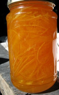 a jar filled with orange liquid sitting on top of a table