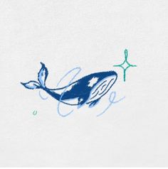 a drawing of a whale on a white t - shirt with blue ink and stars