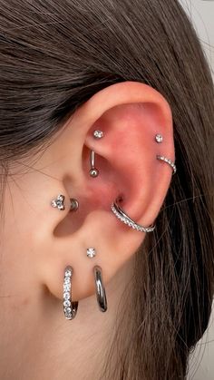 a woman with three different types of piercings on her ear