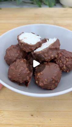 a white plate topped with chocolate covered donuts