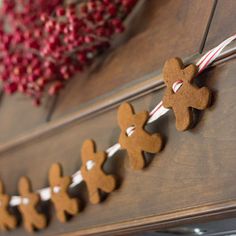 gingerbread cutouts are hanging on the side of a dresser with candy canes