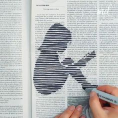 a person is drawing on an open book