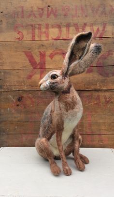 a stuffed rabbit sitting on top of a table