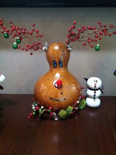 a wooden table topped with snowmen and reindeer figurines