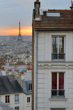 the eiffel tower towering over the city of paris, france as seen from an apartment building