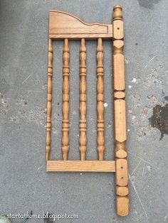 a wooden bed frame sitting on the ground