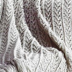 the blanket is crocheted with white yarn