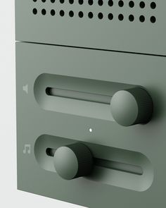 an electronic device with two knobs on the front and back of it, in grey