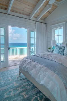 a bedroom with a large bed sitting next to an open door leading to the ocean