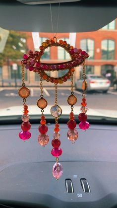 a car dashboard with a wind chime hanging from it's side