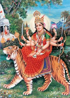 the hindu goddess sitting on top of a tiger