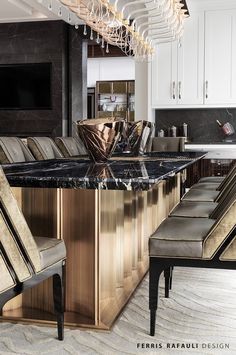 a large kitchen with marble counter tops and wooden cabinets, along with an island in the middle