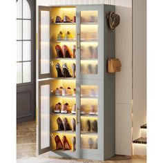 the shoe cabinet is open and has many pairs of shoes in it