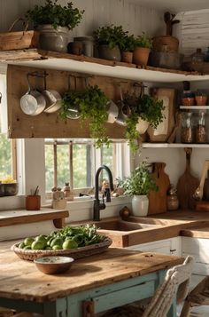 a kitchen filled with lots of pots and pans on top of a wooden table