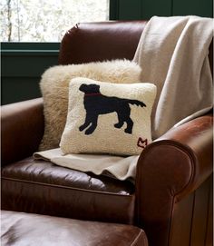 a dog pillow sitting on top of a brown chair